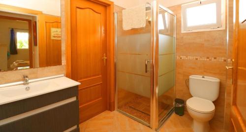 a bathroom with a shower and a toilet and a sink at Can Olivaret in Campos