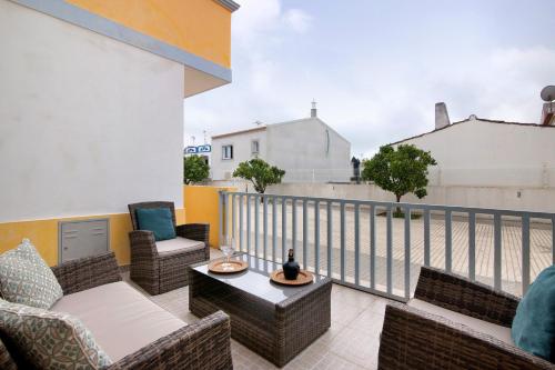 a balcony with chairs and a table on a balcony at Villa Essence of Grey in Manta Rota