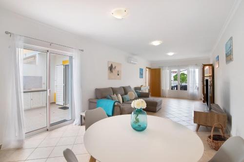 a living room with a table and a couch at Villa Essence of Grey in Manta Rota