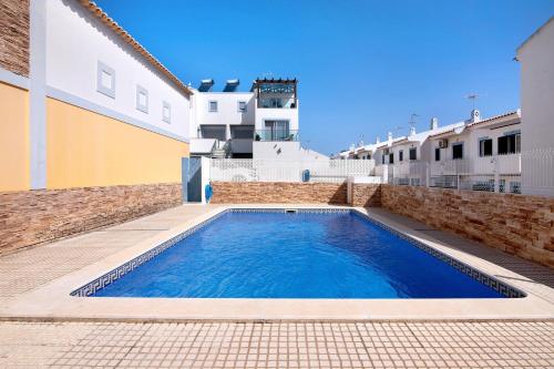a swimming pool in the courtyard of a building at Villa Essence of Grey in Manta Rota