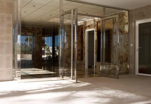 an empty lobby of a building with glass doors at Front Line on the beach in Calpe