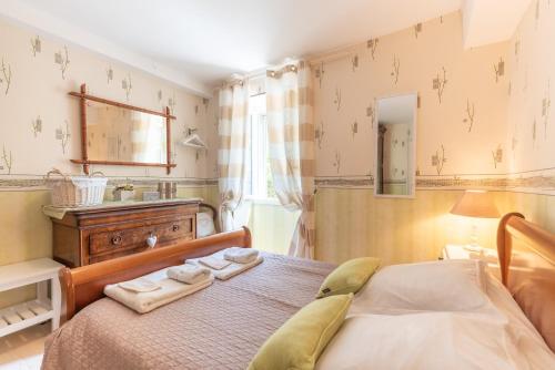 a bedroom with a bed with two towels on it at Gite Bellevue Accous in Accous