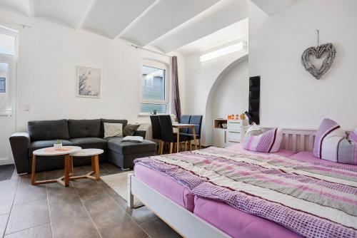 a bedroom with a large bed and a couch at Peenecamp Neukalen, Campingplatz in Neukalen
