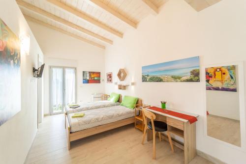 a bedroom with a bed and a desk at Capriccio Mediterraneo in Sassari