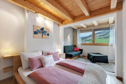 a bedroom with a large bed and a window at Ciasa Irene App Mansarde in La Villa