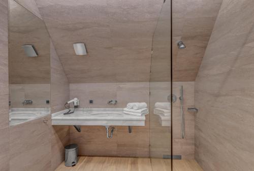 a bathroom with a sink and a glass shower at Villa Wierchy in Zakopane