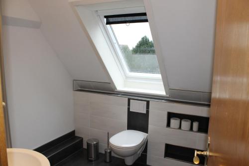 a bathroom with a toilet and a window at Wat(t) ne Wohnung in Büsum