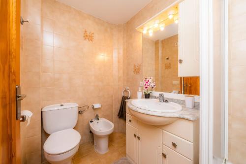 a bathroom with a toilet and a sink at Es Pujol in Alcudia