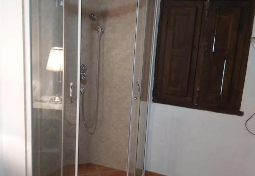 a bathroom with a shower with a glass door at Townhouse Almunecar Old Town in Almuñécar