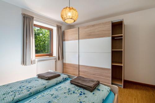 a bedroom with two beds and a window at Gatscherhof Apt Abendrot in Luson