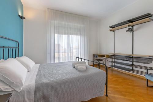 a white bedroom with a bed and a window at Casa vacanze Brezza di Levante in Sestri Levante
