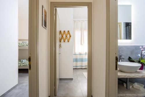 a bathroom with a sink and a mirror at Villa Alba in Costa Paradiso