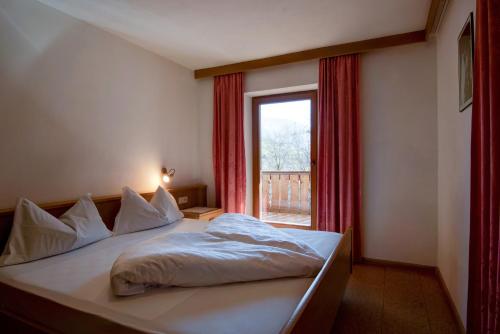 a bedroom with a large bed with a window at Apartment 3 - Zur Sonne in Laion