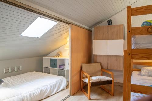 a bedroom with a bunk bed and a chair at Cosy Studio Mezzanine in Allevard