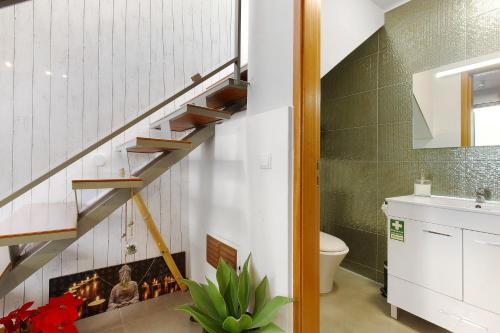 a bathroom with a staircase with a fire place at Sissi Lanço Sea View 7 in Funchal