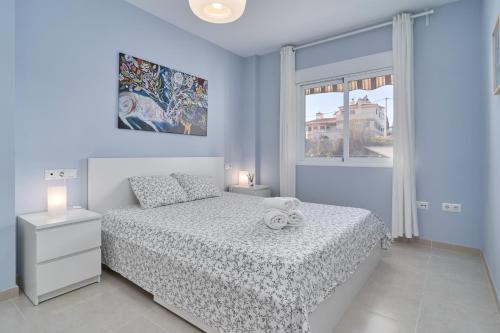 a bedroom with a white bed and a window at Recreo 10 in Torrox
