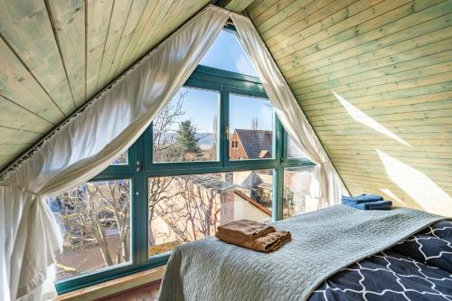 a bedroom with a bed and a large window at Elbloft Radebeul Am Elberadweg Mit in Radebeul