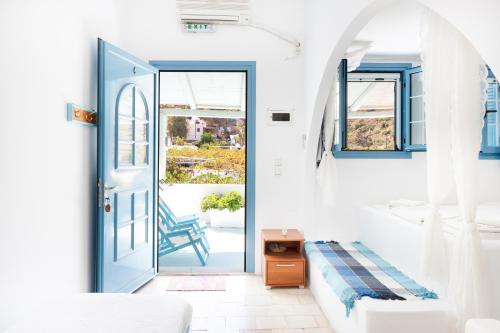 a bedroom with a door leading to a balcony at Beachfront Lampis Dolphin 4 in Skala