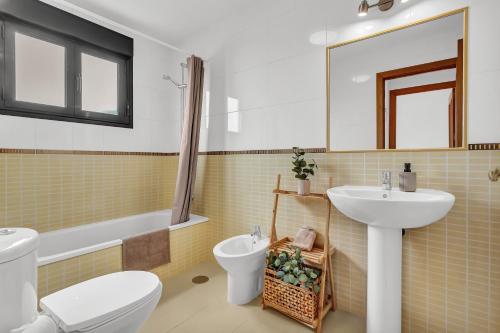 a bathroom with a sink and a toilet and a sink at Villa Manuela in Lajares