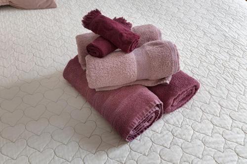 a pile of purple towels on a bed at La Rosa Dei Venti in Vernazza