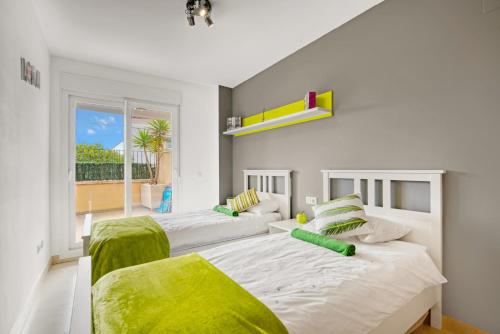 a bedroom with two beds and a balcony at Amanda in Jávea