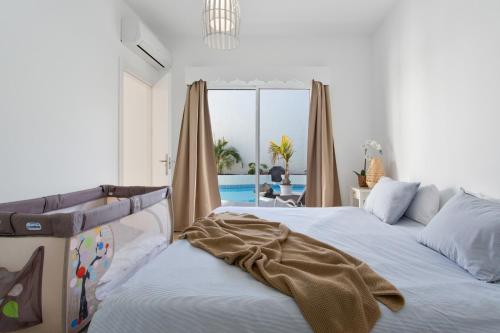 a bedroom with two beds and a view of the ocean at Villa Ole Bahiazul-Private Jacuzzi in Corralejo