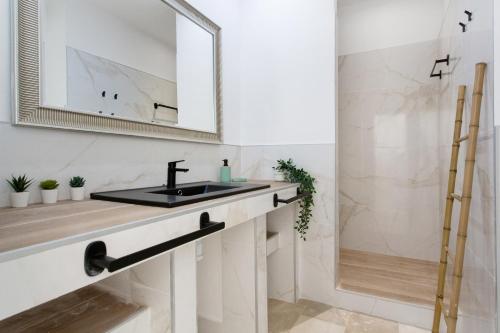 a bathroom with a sink and a mirror at Villa Ole Bahiazul-Private Jacuzzi in Corralejo