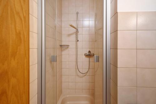 a bathroom with a shower with a toilet and a sink at Pension Schneider in Freiamt