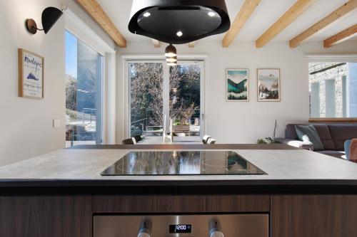 a kitchen with a sink and a living room at La Maison du Renard in Sarre
