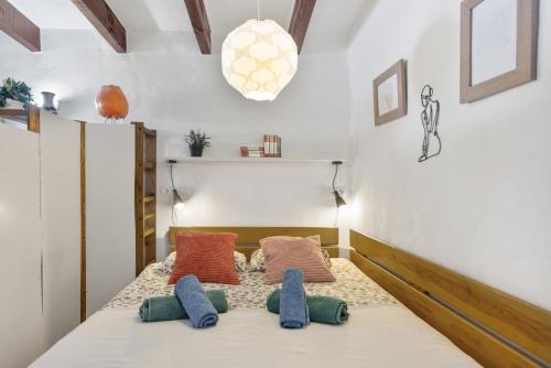 a bedroom with a bed with pillows on it at Can Vital 2 in Illes Balears