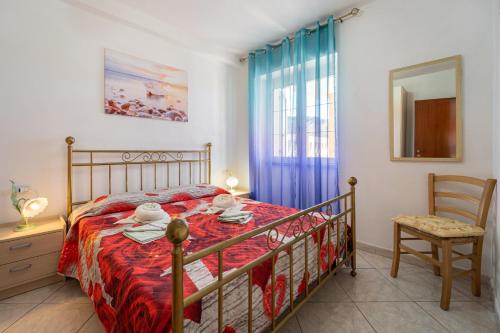 a bedroom with a bed and a chair and a window at Casa Flavia in Nebida