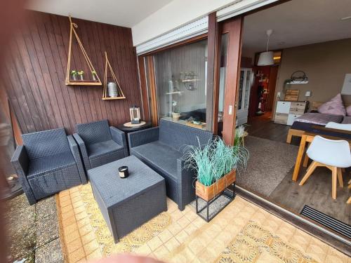 a living room with a couch and chairs and a table at Schwarzwald Heimat mit Pool, Sauna in Schönwald