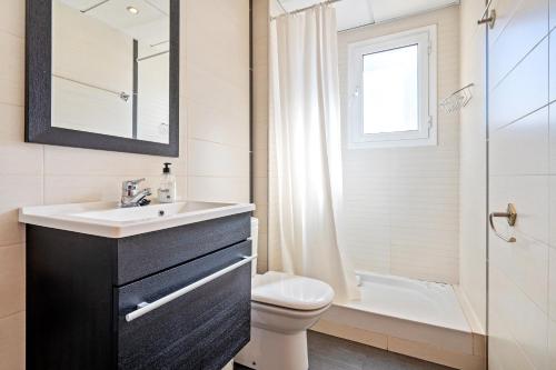 a bathroom with a sink and a toilet and a shower at Dorada Apartment Mar in Calafell