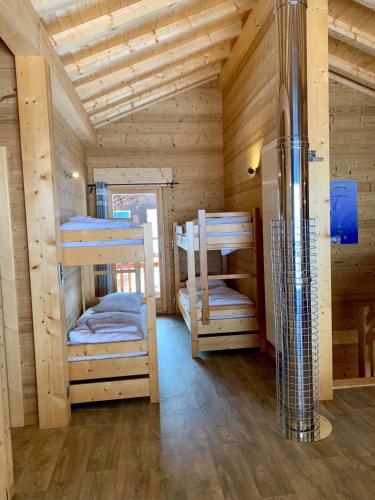 a room with two bunk beds in a cabin at Chez Gilles chalet haute cimes in Châtel