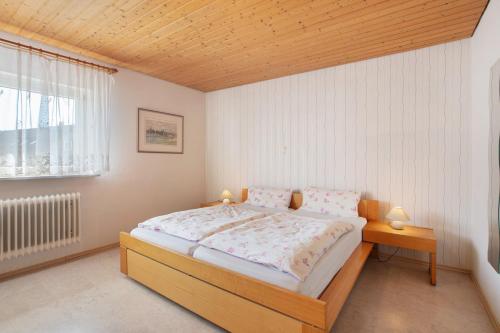 a bedroom with a large bed and a window at Ferienwohnung Rehm in Bad Säckingen