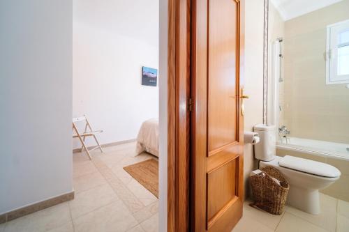 a bathroom with a toilet and a tub and a sink at Villa Del Sol - Solo Familias 1819 in Jávea