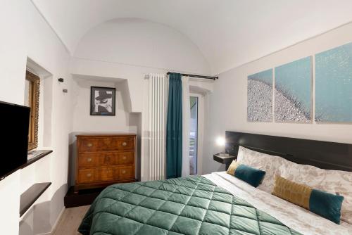 a bedroom with a green bed and a window at Magia e Luce in Sanremo