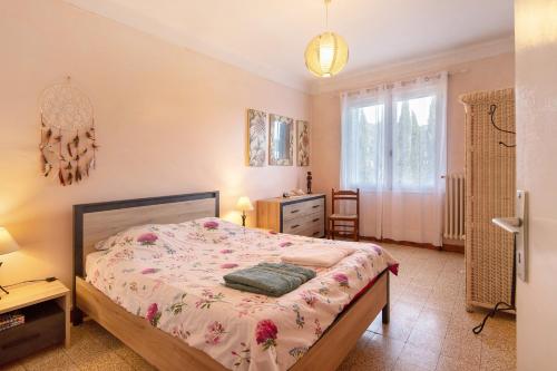a bedroom with a bed and a dresser at Le Vigan, balcon, parking, animaux in Le Vigan