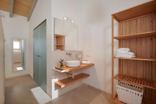 a bathroom with a sink and a mirror at Son Rossinyol Nou - Ses Figueretes in Islas Baleares