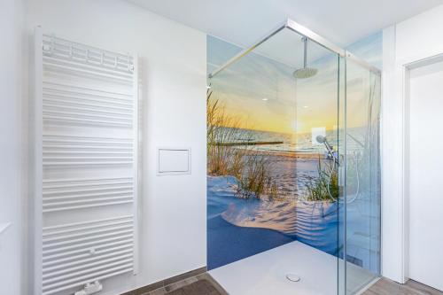 a bathroom with a shower with a painting of a beach at Haus Luise in Bramstedtlund
