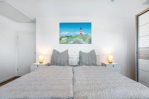 a bedroom with a large bed and a lighthouse at Haus Luise in Bramstedtlund