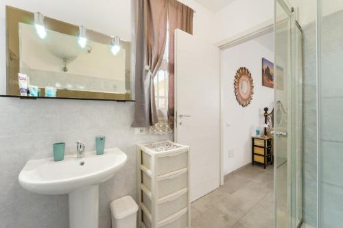 a white bathroom with a sink and a shower at Casa Vacanza Da Gabry in Perdaxius
