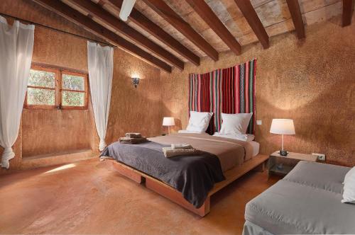 a bedroom with a bed with a red headboard at Son Garreta in El Palmer