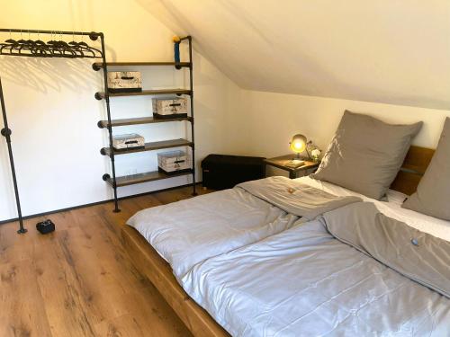 a large bed in a room with a ladder at Ferienhaus Riedlodge Bodensee-Obers in Guggenhausen