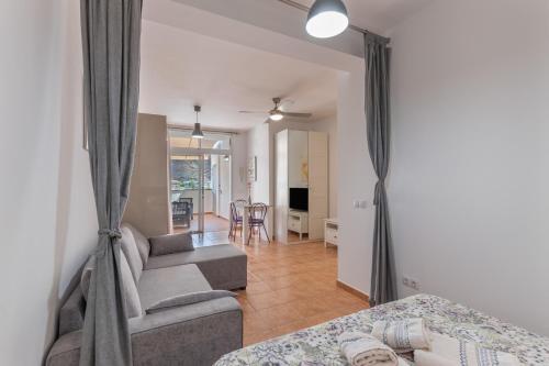 a living room with a couch and a bed and a living room at Vv Faro in Puerto de Mogán