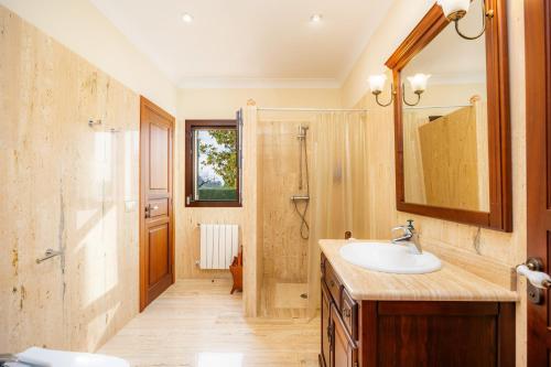 a bathroom with a sink and a shower at El Olivar in El Port de la Selva