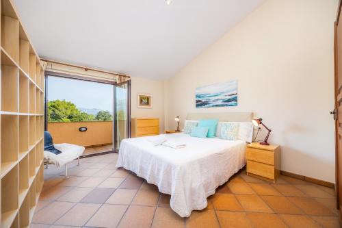 a bedroom with a bed and a large window at El Olivar in El Port de la Selva