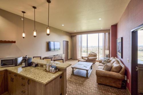 a kitchen and living room with a couch and a table at Choctaw Casino & Resort Pocola, Trademark Coll by Wyndham in Pocola