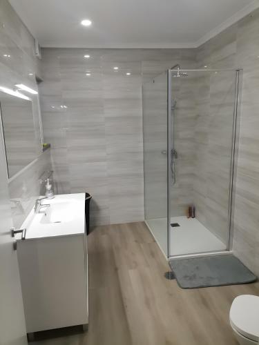 a bathroom with a shower and a sink at Casa do Carapacho in Luz