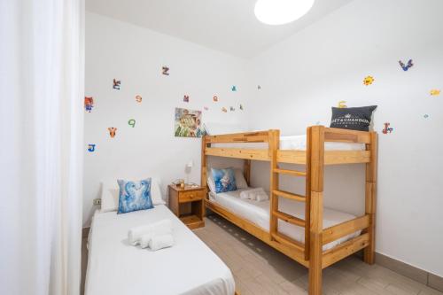two bunk beds in a room with white walls at Rossini 14 Centro e Mare a Piedi in Porto Cesareo